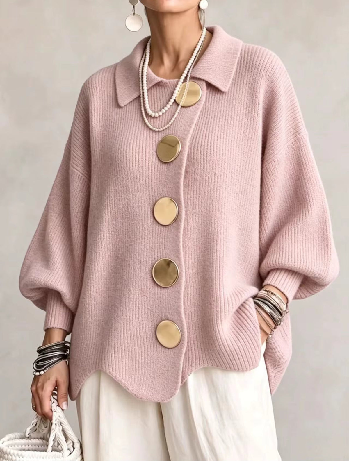 Front view of the soft pink version on a model, showing the statement gold buttons and wavy bottom edge. 6