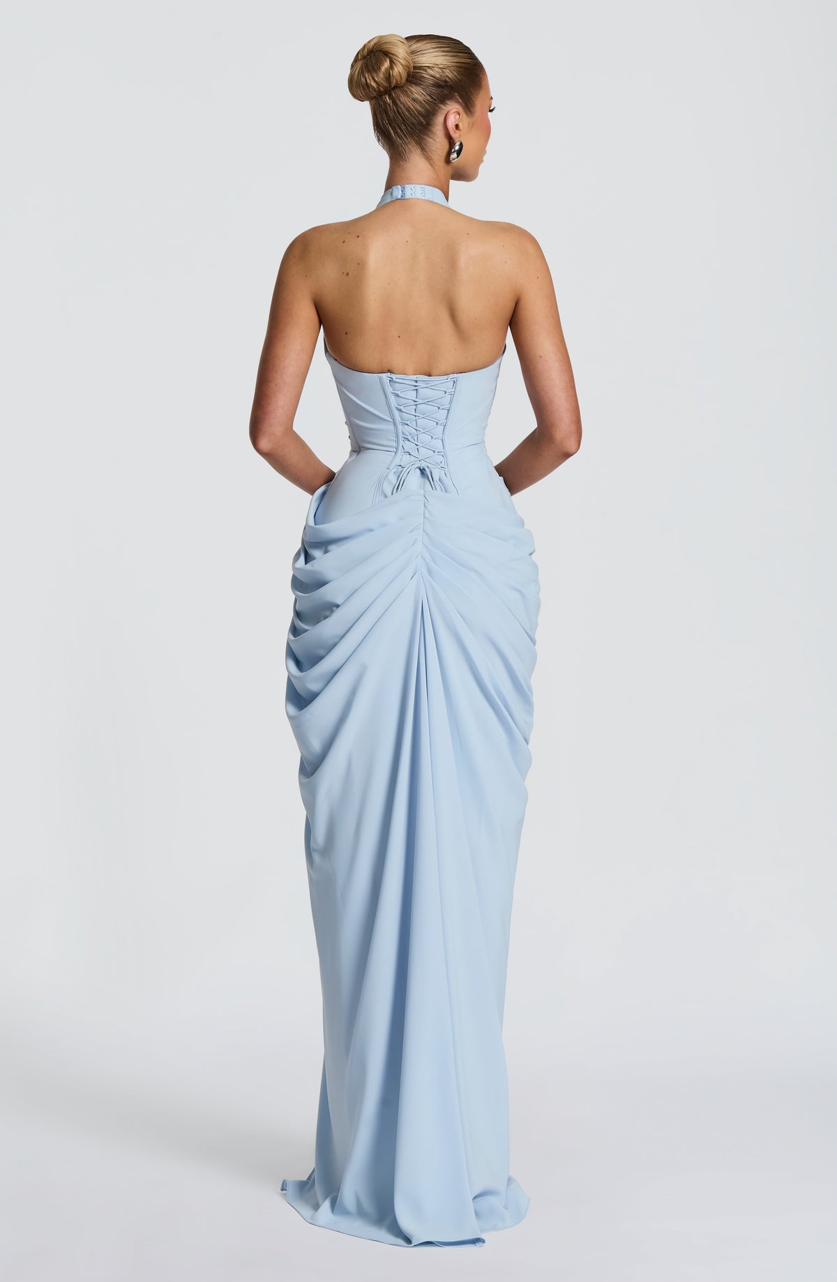 Back view of the pale blue dress showing the lace-up corset back, halter clasp and gathered, ruched skirt. 10