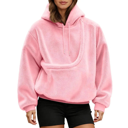 Front view of a pink fluffy hoodie on a model, showing the empty curved kangaroo pouch and drawstring hood. 12