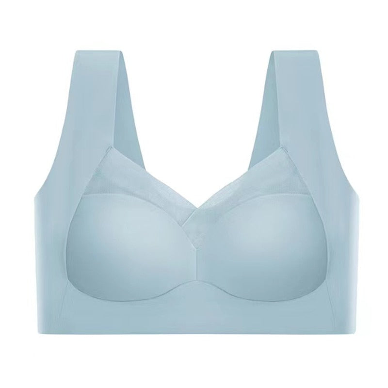 Pale blue seamless bra laid flat against a white background, showing the mesh neckline panel, wide straps and smooth cups. 10