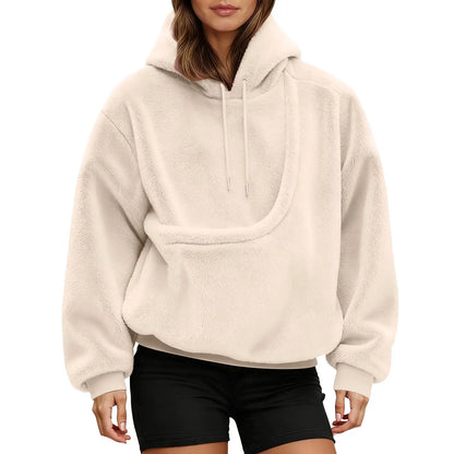 Front view of a cream fluffy hoodie on a model, showing the empty curved kangaroo pouch and drawstring hood. 11