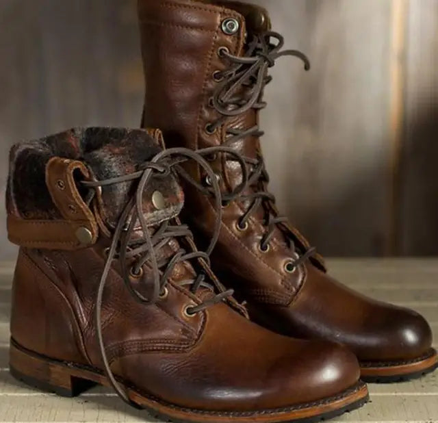 Pair of brown leather lace-up boots, one with its top folded down to show the soft patterned fabric lining. 1