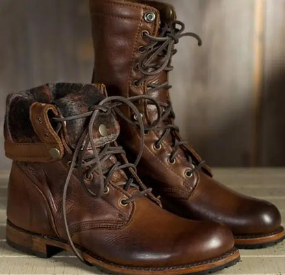 Pair of brown leather lace-up boots, one with its top folded down to show the soft patterned fabric lining. 1