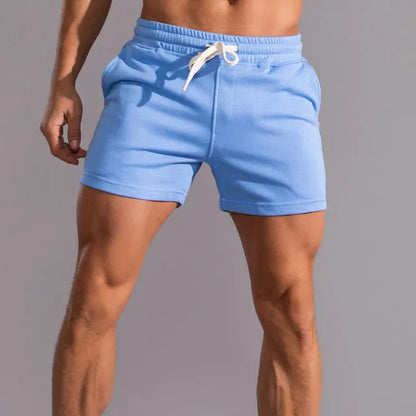 Sky blue shorts with a white drawstring and slightly turned-up hems, worn by a model against a grey background. 5