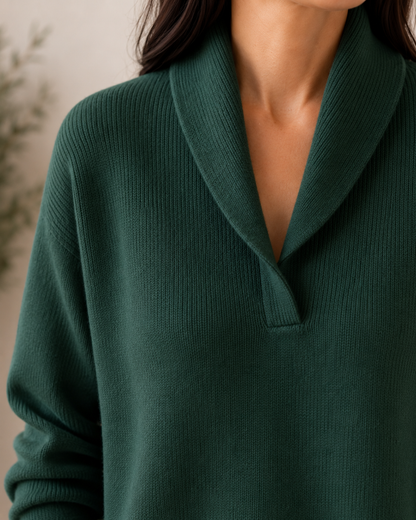 Close-up of the dark green jumper's shawl collar and V-neck opening, showing the fine ribbed knit texture. 12