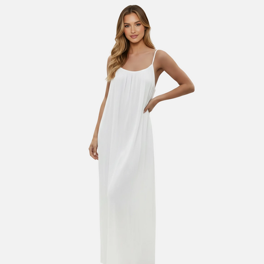 Woman wearing a white dress on a plain background