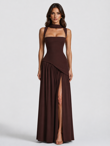 Front view in dark chocolate brown on a model, showing the square-neck corset bodice, neck scarf, asymmetric gathered skirt and high thigh slit. 1