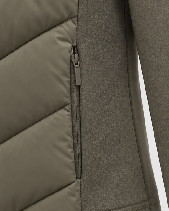Close-up of the zipped side pocket on the khaki-green jacket, where quilted fabric meets the soft stretch side panel. 3