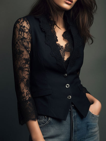 Three-quarter view of the black top on a model, showing the lace collar, one sheer lace sleeve and flap pocket. 7