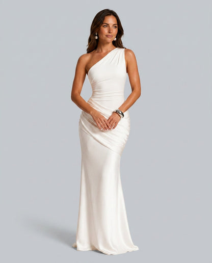 Model wearing the ivory version, front view, with pearl drop earrings and a chunky silver cuff. 3