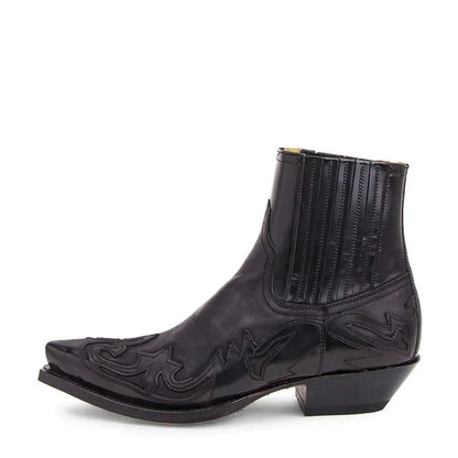 Side view of a black leather Western ankle boot with pointed toe, stitched overlay patterns, elasticated side panel and stacked heel. 1