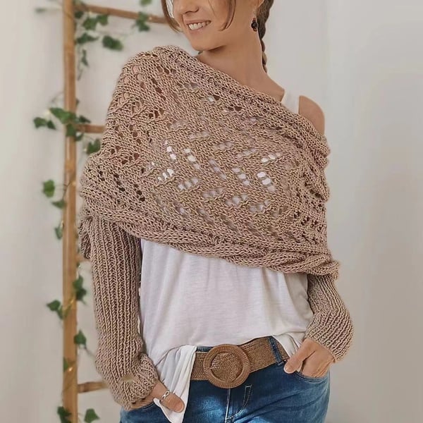 Taupe open-weave lace wrap worn off one shoulder over a white top, with a woven belt at the jeans. 20