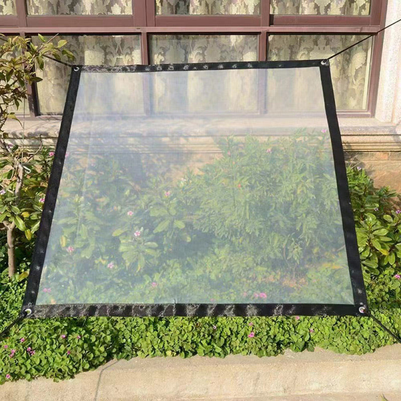 Clear tarpaulin with black border tied out by cords above a flowerbed, shielding plants beneath it while remaining see-through. 7