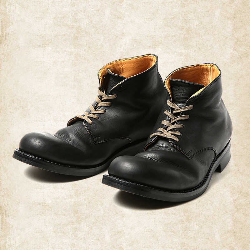 Black leather lace-up ankle boots with tan laces and a tan leather lining visible at the collar, shown at a three-quarter angle. 2
