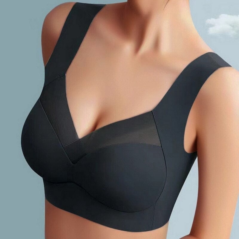 Model wearing the black wide-strap bra from the front, showing the mesh neckline panel and smooth seamless cups. 4