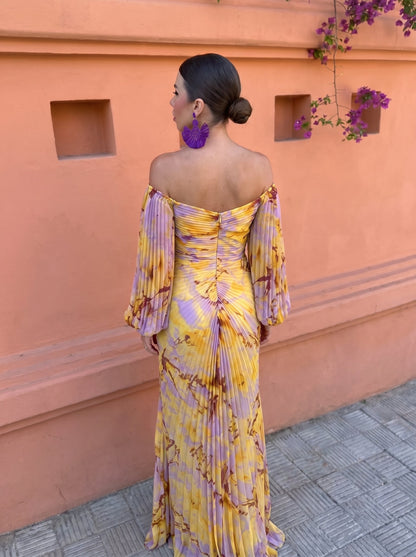 Full-length back view of the model in the dress, showing the zip, pleated puffed sleeves and floor-length pleated skirt. 4