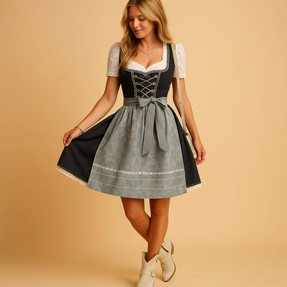 Full-length view of the dirndl worn with cream ankle boots, the model lifting the skirt to show its flared shape and lace trim. 3