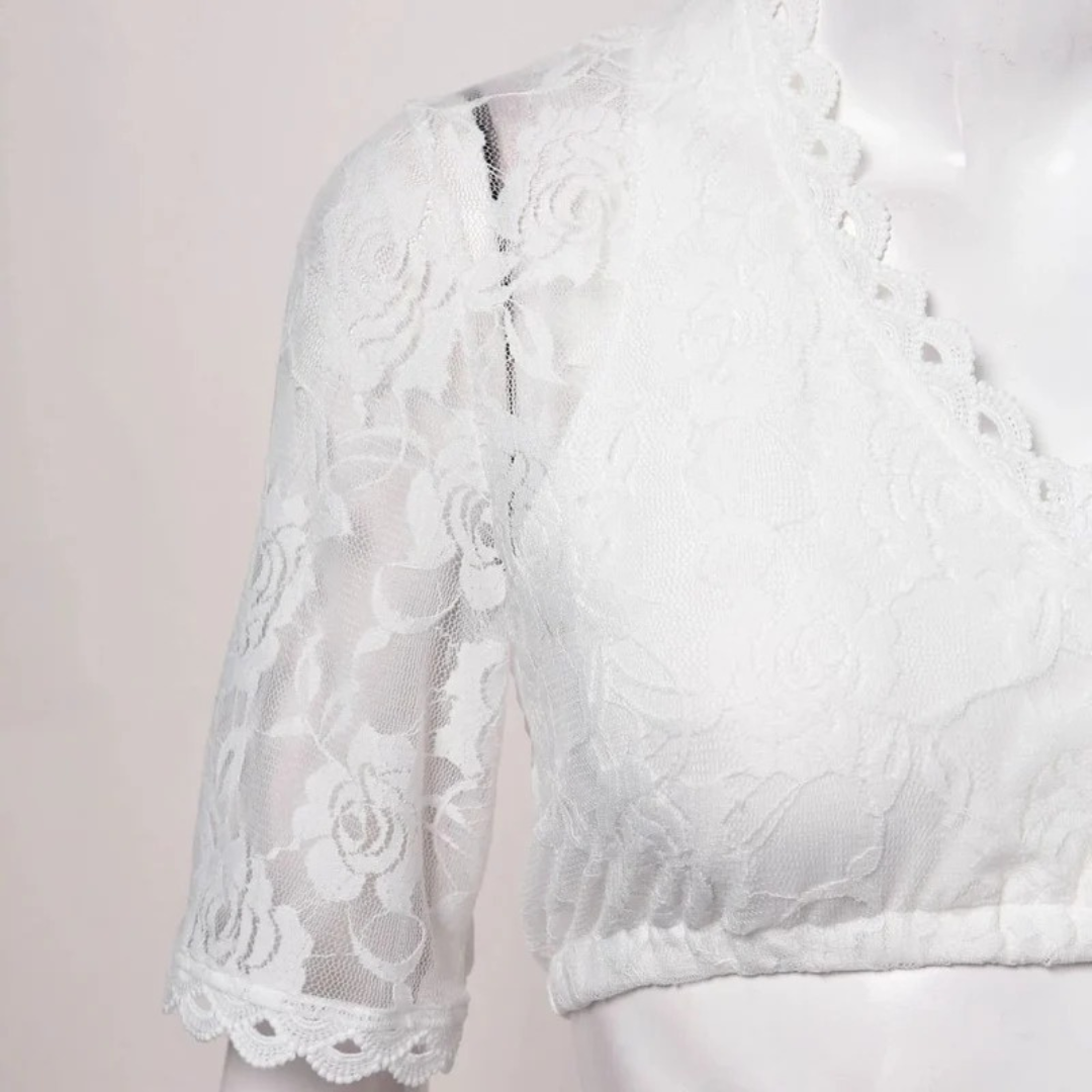 Close-up of the rose lace sleeve and scalloped neckline on a mannequin, with the elasticated hem visible at the bottom. 4