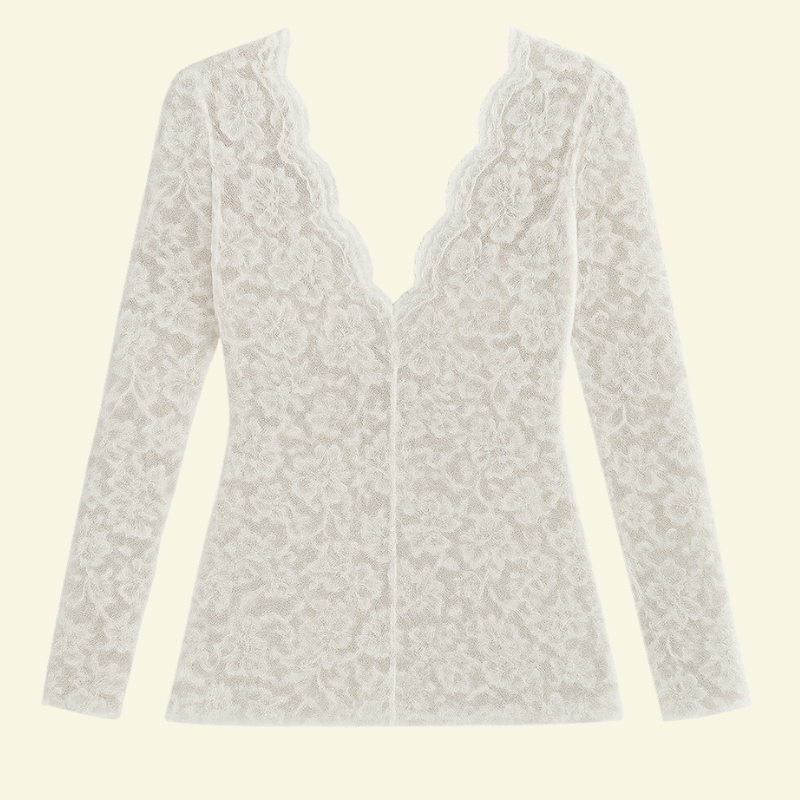 Flat lay of the white lace top on a plain background, showing the scalloped V-neck, long sleeves and floral pattern. 5
