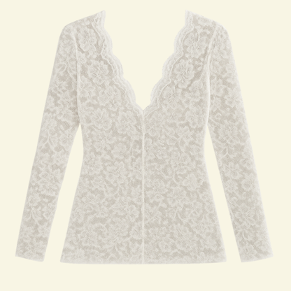 Flat lay of the white lace top on a plain background, showing the scalloped V-neck, long sleeves and floral pattern. 5