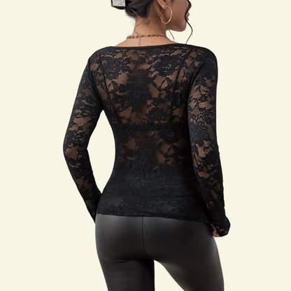 Back view of the black lace top on a model, showing the sheer floral lace across the back and sleeves. 6