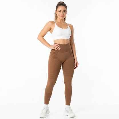 Front view of caramel brown high-waisted leggings with patterned hip and thigh panels, worn with a white sports bra. 17