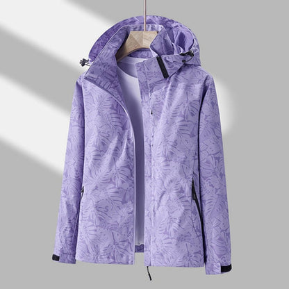 Second view of the lilac leaf-print hooded jacket on a hanger, open at the front with black zip pockets and cuff tabs. 2