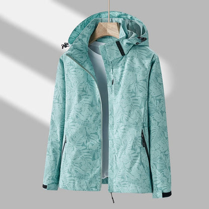 Mint green leaf-print version of the hooded jacket on a hanger, open at the front, with black pocket zips and cuff tabs. 7