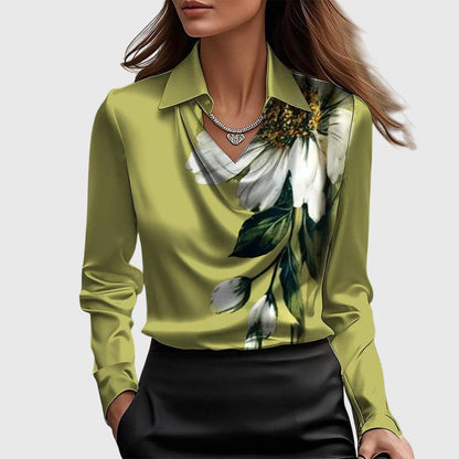 Model wears the olive-green satin blouse with a large white flower and leaves printed down one side, with black skirt. 7
