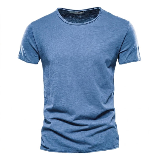Front view of the short-sleeved crew neck t-shirt in mid blue, showing the streaky slub texture and raw-edged hems. 1