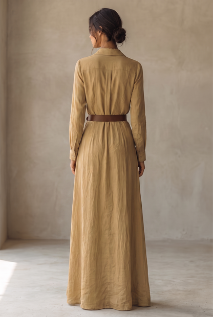 Back view of the camel maxi dress, showing the shirt-style collar, button cuffs, pleated back yoke and belt fastened at the waist. 3