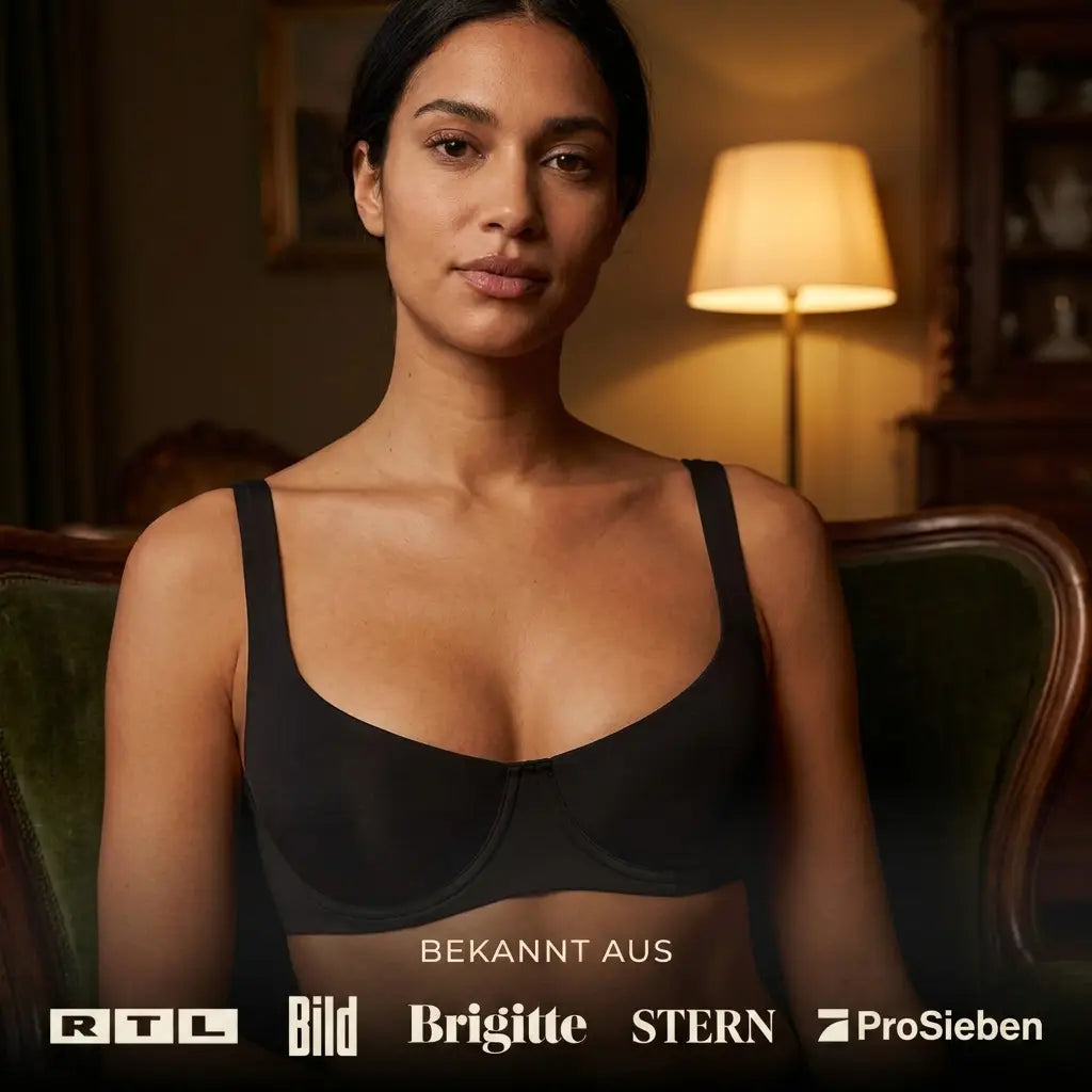Woman with dark hair sitting in an armchair in a black balconette bra, with a row of media logos along the bottom. 4