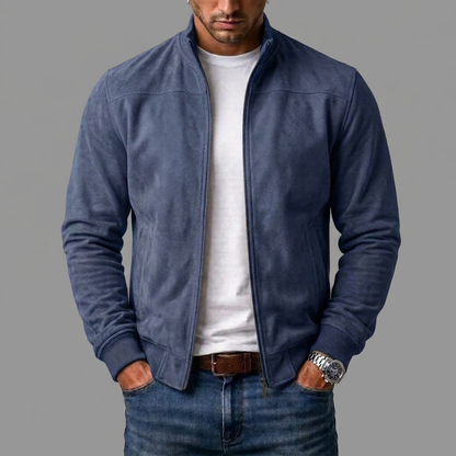 Dusky navy blue suede bomber on a model, ribbed cuffs visible, worn over a white t-shirt and denim jeans. 6