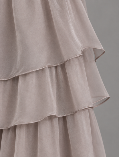 Close-up of the taupe chiffon skirt tiers, showing the soft sheer layers and delicate rolled hems. 20