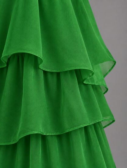 Close-up of the layered green organza ruffles, showing the stitched hems and gathered tiers. 32