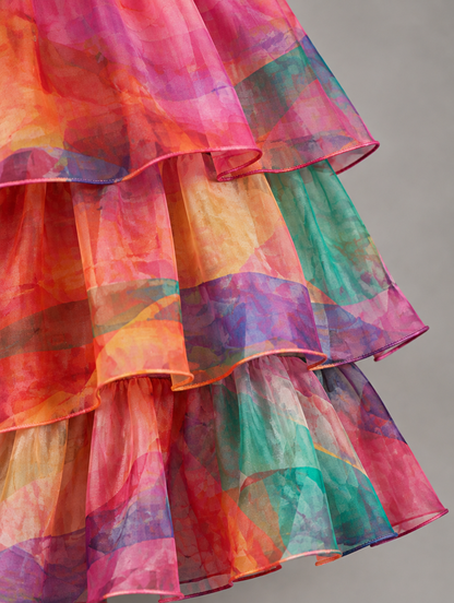 Close-up of the layered organza ruffles in a vibrant pink, orange, purple and teal watercolour print. 38