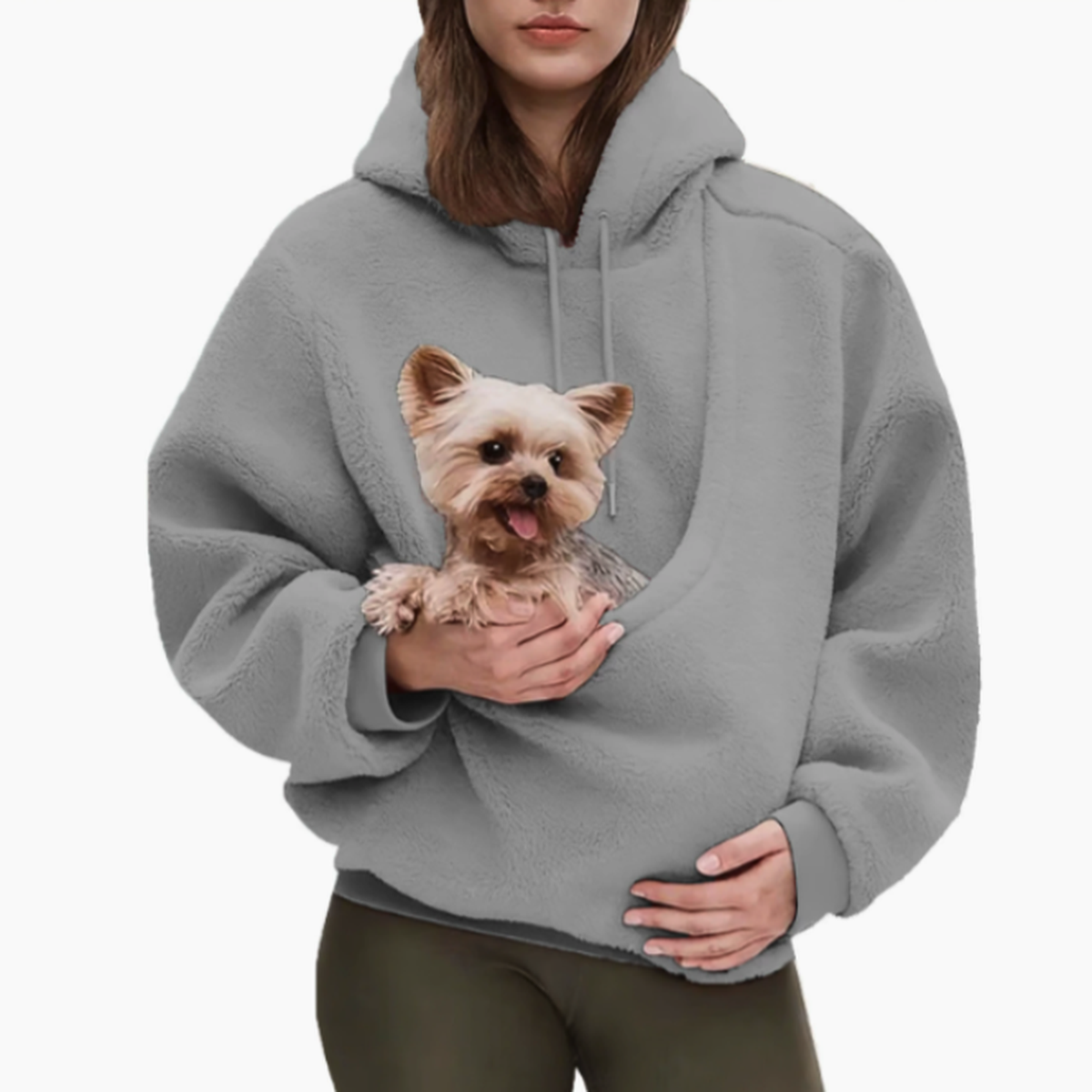 Woman in a grey teddy-fleece hoodie with olive leggings, holding a small terrier in the front pouch. 7