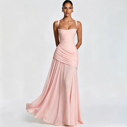Soft pink dress on a model, front view with square neckline, side draping and flowing chiffon-like skirt. 19