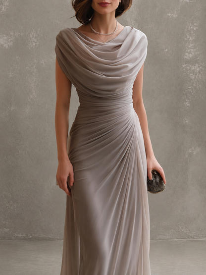 Close-up of the taupe-grey dress from neckline to thigh, showing the soft cowl drape and the diagonal ruching at the waist. 7