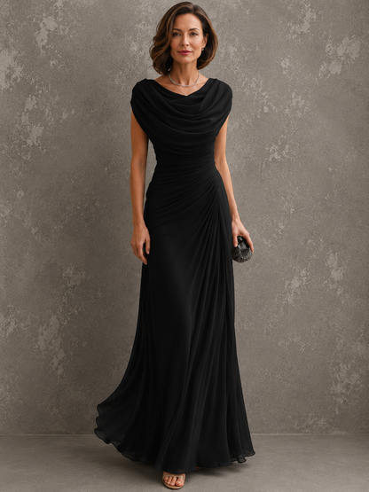 Model standing in the black version of the draped chiffon maxi dress, showing the cowl neckline, ruched side and floor-length skirt. 2