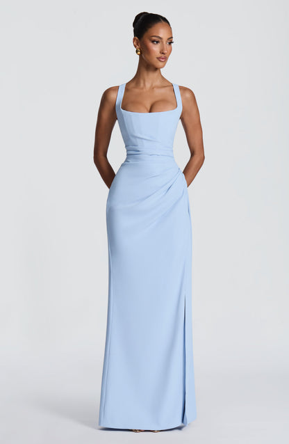 Front view of the pale blue dress on a model, arms behind her, showing the fitted bodice and floor-length skirt. 27
