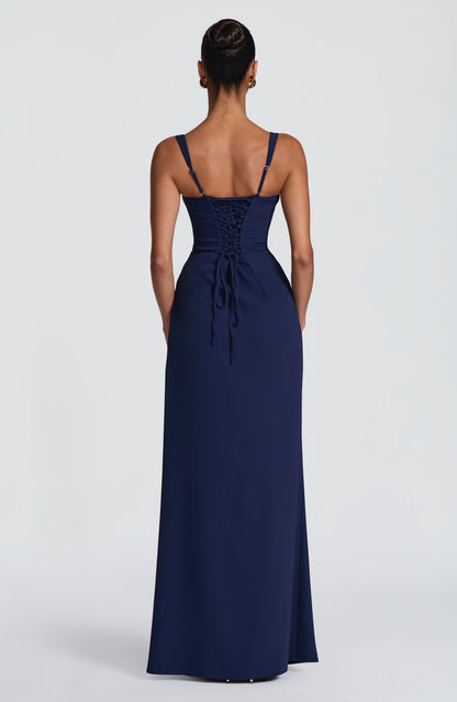 Back view of the navy maxi dress showing lace-up corset back and adjustable thin straps. 11