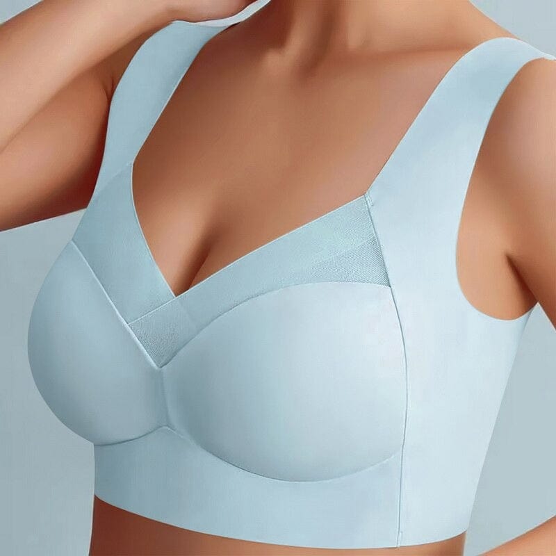 Model wearing the pale blue wide-strap bra from the front, showing the mesh neckline panel and smooth seamless cups. 5