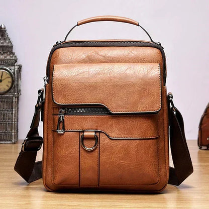 Front view of the tan shoulder bag showing the flap pocket, zip pocket, metal ring and adjustable brown strap. 5