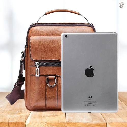 Tan shoulder bag beside a tablet standing in front of it, showing the bag is big enough to carry one. 9
