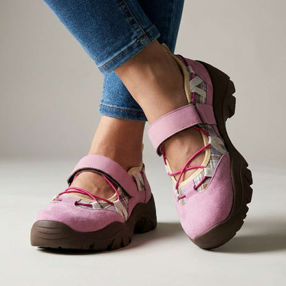 Pink suede shoes with plaid panels, bright pink elastic laces and a chunky brown sole, worn with rolled blue jeans. 4