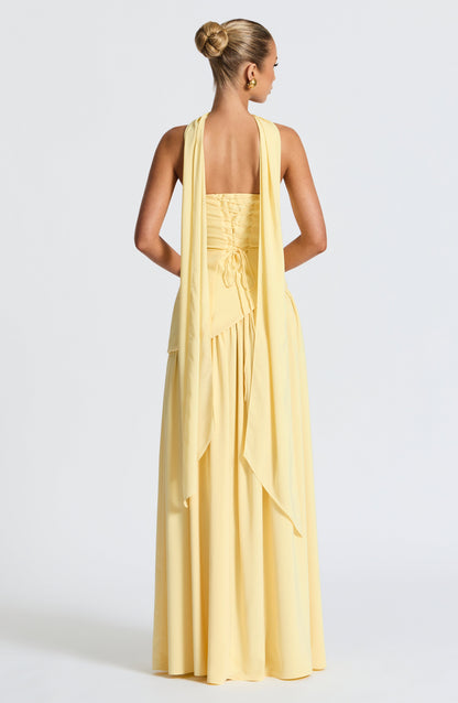 Back view of the pale yellow dress, showing the lace-up corset back and scarf panels draped down the back. 4