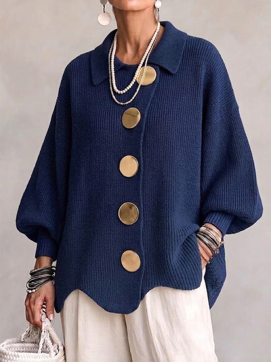 Woman wearing the navy ribbed knit cardigan from the front, showing the wide collar, five large gold buttons and scalloped hem. 1