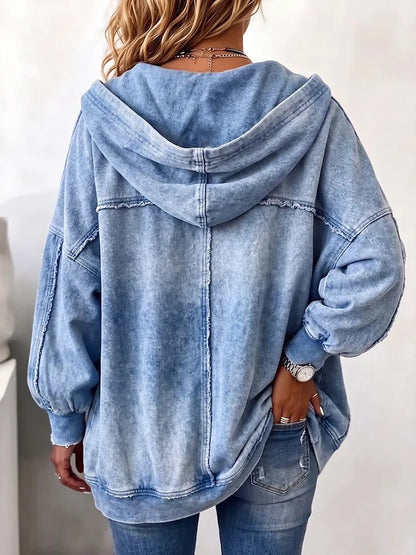 Back view of the faded blue hooded jacket on a model, showing the centre seam, raw-edge stitching and ribbed cuffs. 2