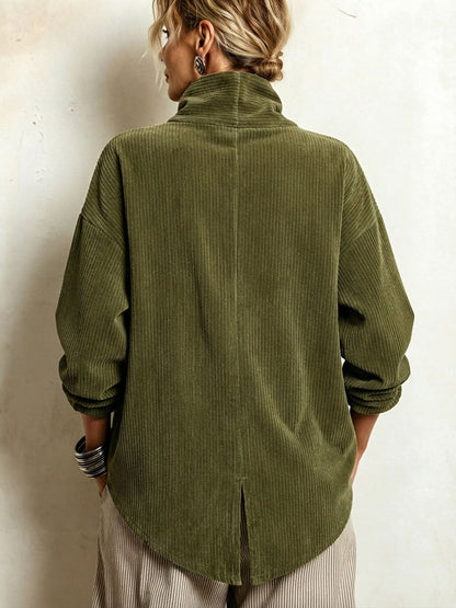 Back view of the olive corduroy top on a model, showing the high collar, centre seam, rounded hem and small vent. 4
